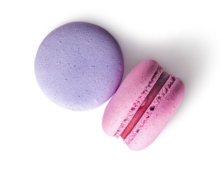 Two macaroon purple pink top view on white background