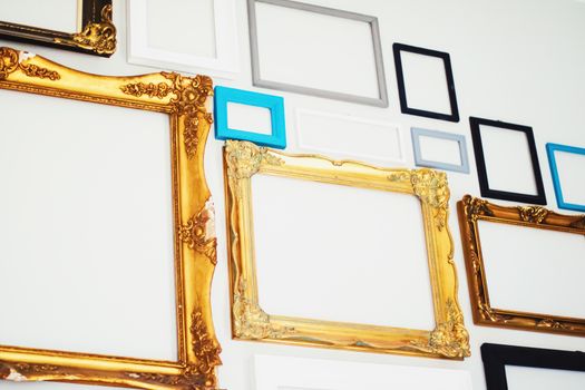 Empty art frames on gallery wall, decor and design details