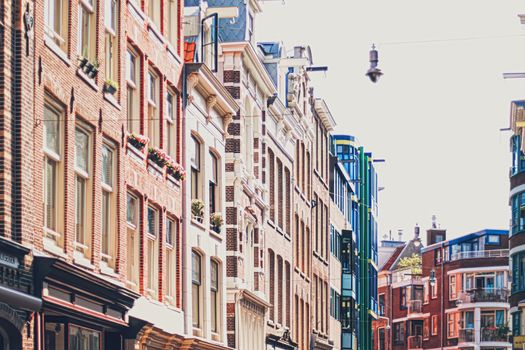 Main downtown street in the city center of Amsterdam in Netherlands on sunny day