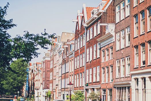 Main downtown street in the city center of Amsterdam in Netherlands on sunny day