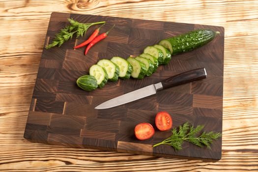 Fresh vegetables and greens on wooden cutting board