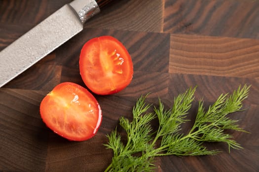 Fresh vegetables and greens on wooden cutting board