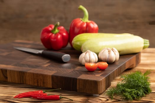 Fresh vegetables and greens on wooden cutting board