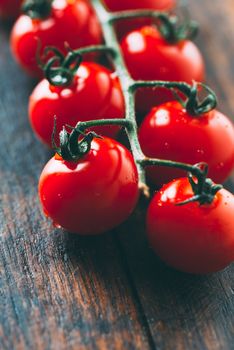 Close up cherry tomatoes on wooden cutting board