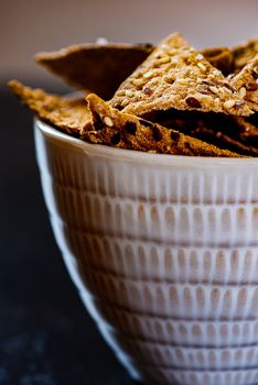 Sesame triangular crispy chips in bowl
