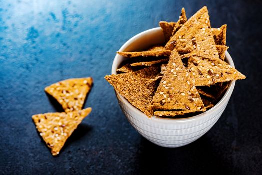 Sesame triangular crispy chips in bowl