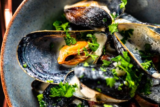 Cooked Blue mussels in clay dish close up
