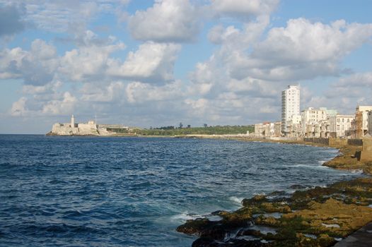 View along the Malecon in Havana, looking towards the lighthouse at Morro Castle.