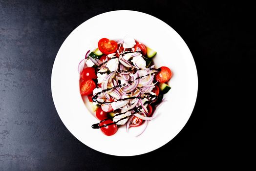 Italian homemade traditional salad with tomato mozzarella onion cucumber