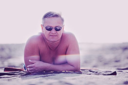 Man relaxing on sandy beach