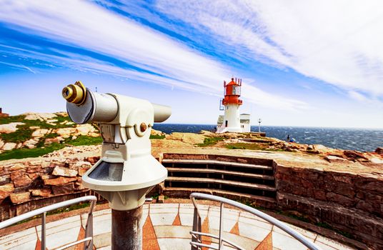 Observation telescope with Lindesnes Lighthouse on background, Norway