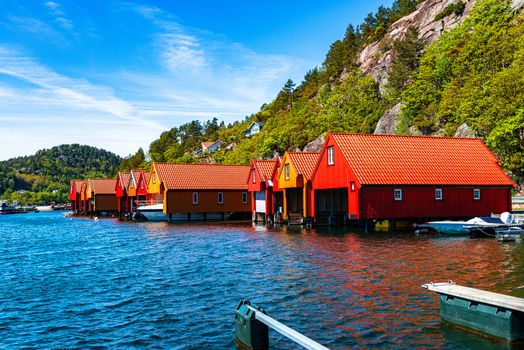 Red and orange houses for keeping boats in Norway
