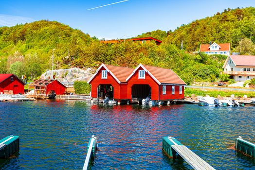 Red and orange houses for keeping boats in Norway