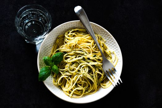 Cooked tasty spaghetti pasta in a bowl, top view