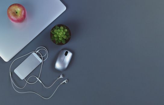 Gray desktop with mobile devices in flat lay format for telework or telecommute concept 