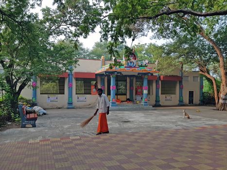 Tiruvanamalai, India - 11 december 2019: Sadhu cleaning in front of a temple in Tiruvanamalai in India