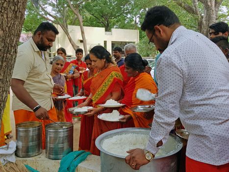 Tiruvanamalai, India - 10 december 2019: Sadhus getting food in the Ramana Ashram in Tiruvanamalai India