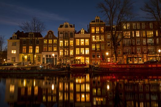 City scenic from Amsterdam at the Amstel in the Netherlands at night