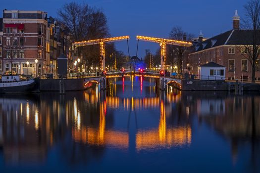 City scenic from Amsterdam at the Amstel in the Netherlands at night