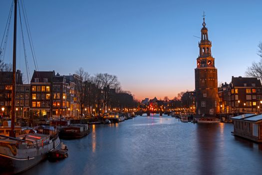 City scenic from Amsterdam with the Montelbaan Tower in the Netherlands at sunset