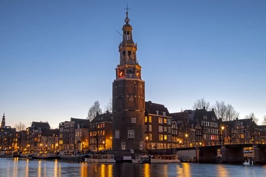 City scenic from Amsterdam with the Montelbaan Tower in the Netherlands at sunset