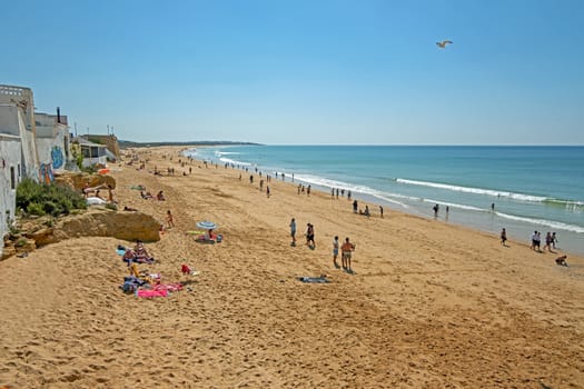 Armacao de Pera, Portugal - April 21, 2019: People enjoying at the beach in Armacao de Pera in the Algarve Portugal