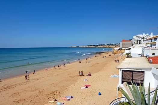 Armacao de Pera, Portugal - April 21, 2019: People enjoying at the beach in Armacao de Pera in the Algarve Portugal