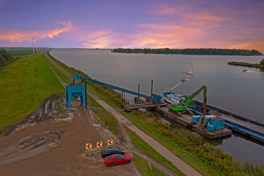 Aerial from freighter unloading sand in the countryside from the Netherlands