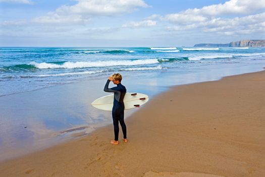 Aerial from a young surfer ready to surf at the atlantic ocean