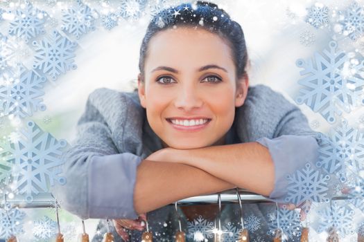 Portrait of fashion designer leaning on clothes against snow