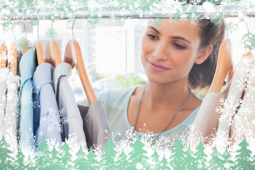 Attractive fashion woman looking at clothes against snow