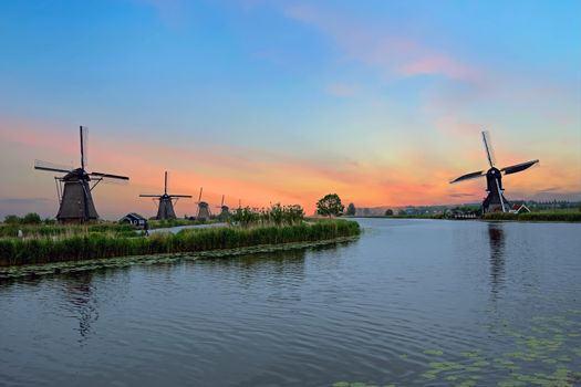 Traditional windmills at Kinderdijk in the Netherlands at sunset