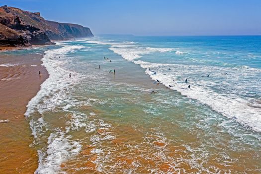 Aerial from surfers getting surfing lessons at the atlantic ocean