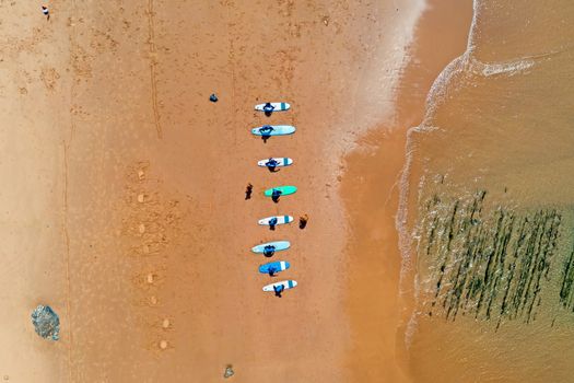 Aerial top shot from surfers getting surfers lessons at Praia Vale Figueiras in Portugal