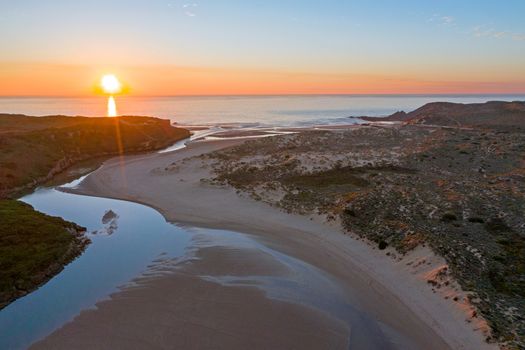 Aerial from Amoreira beach on the westcoast in Portugal at sunset