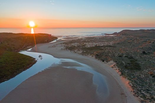Aerial from Amoreira beach on the westcoast in Portugal at sunset