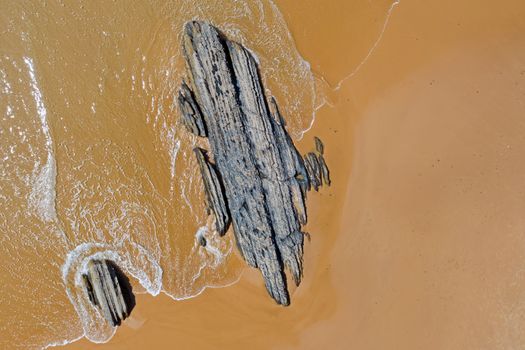 Aerial from natural rocks on Vale Figueiras beach in Portugal