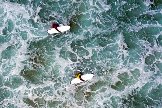 Aerial from surfers getting surfers lessons in the atlantic ocean