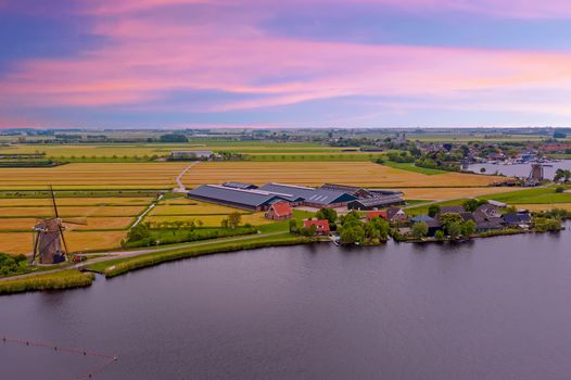 Aerial from a typical dutch landscape with windmills, water en far views. 