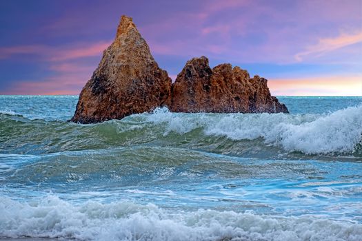 Natural rocks at praia Tres Irmaos in Alvor Algarve Portugal at sunset