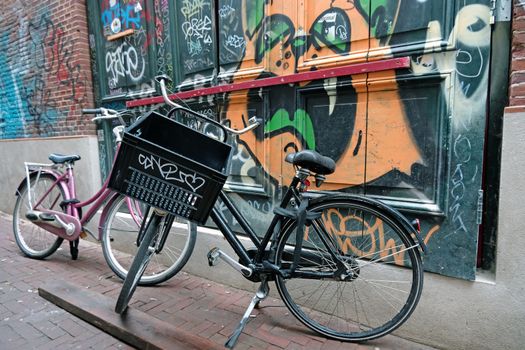 Dutch bikes against a grafitti wall in Amsterdam the Netherlands