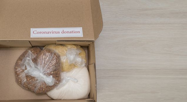 flat lay coronavirus donation box with long term food supplies