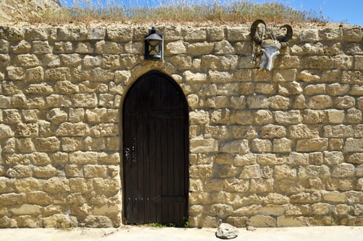 In the suburbs of Baku, a utility room, with a wooden door, and an amulet