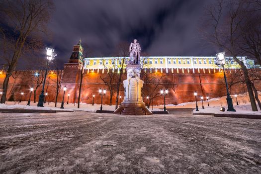 Monument to Emperor Alexander I in Moscow with Kremlin wall behind during winter night