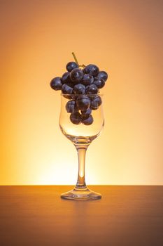 Conceptual idea of grapes in the wine glass as raw material instead of  final product