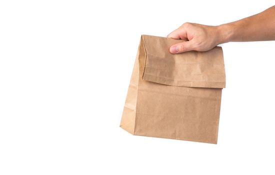 Man holding a brown paper bag isolated on white