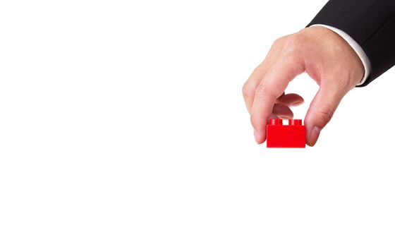 hand stacking a plastic block