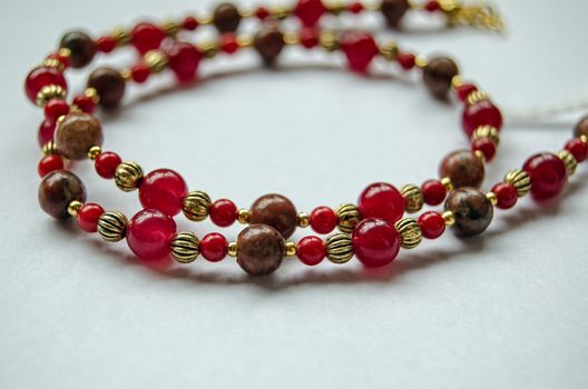Jewellery handcrafted from jasper,coral and agate beads separated with gold plated metal beads.  