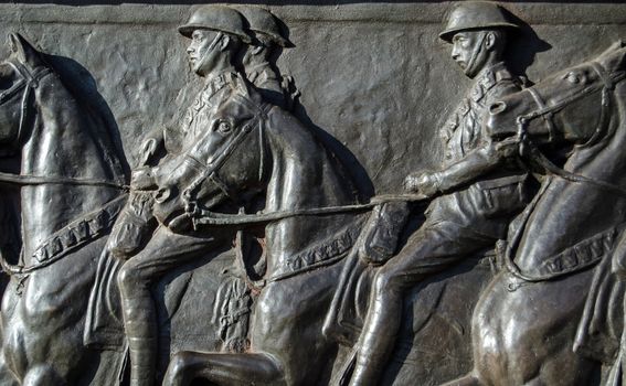 Detail of the bronze frieze of World War I soldiers riding their horses on the Cavalry Monument dedicated to those killed fighting.  Sculpted in 1921 by Adrian Jones an on public display in Hyde Park, London.