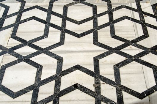 Geometric black and white floor tiles.